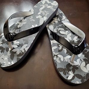 Black and white Michael Kors flip flops